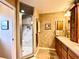 Bathroom with a glass shower stall, vanity cabinet, and decorative mirror at 15715 Sw 11Th Terrace Rd, Ocala, FL 34473