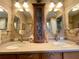 Bathroom featuring double sinks, vanity cabinets and decorative mirrors at 15715 Sw 11Th Terrace Rd, Ocala, FL 34473