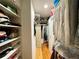 Spacious walk-in closet with custom shelving, hanging rods and wood flooring at 15715 Sw 11Th Terrace Rd, Ocala, FL 34473