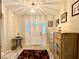 Inviting foyer boasts tile flooring, cabinet with beach scene, decorative rug, and front door with glass at 15715 Sw 11Th Terrace Rd, Ocala, FL 34473