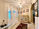 Inviting foyer boasts tile flooring, cabinet with beach scene, decorative rug, and front door with glass at 15715 Sw 11Th Terrace Rd, Ocala, FL 34473