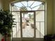 Covered entry features a decorative storm door with lush exterior and patterned walkway at 15715 Sw 11Th Terrace Rd, Ocala, FL 34473