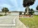 Inviting home showcasing palm trees, lush landscaping, and an attractive decorative driveway at 15715 Sw 11Th Terrace Rd, Ocala, FL 34473