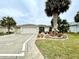 Inviting home showcasing palm trees, lush landscaping, and an attractive decorative driveway at 15715 Sw 11Th Terrace Rd, Ocala, FL 34473