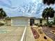 Charming home featuring a decorative driveway, tropical landscaping, and a welcoming entrance at 15715 Sw 11Th Terrace Rd, Ocala, FL 34473