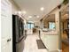 Modern kitchen features stainless appliances and granite counters, adjacent to the living space at 15715 Sw 11Th Terrace Rd, Ocala, FL 34473