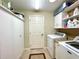Bright laundry room featuring cabinets, shelving, washer and dryer units at 15715 Sw 11Th Terrace Rd, Ocala, FL 34473