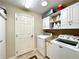 Functional laundry room with ample storage cabinets, countertops, washer and dryer at 15715 Sw 11Th Terrace Rd, Ocala, FL 34473