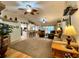 Spacious living room with hardwood floors, comfortable seating, ceiling fans, and access to the kitchen at 15715 Sw 11Th Terrace Rd, Ocala, FL 34473
