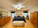 Spacious main bedroom featuring hardwood floors, ceiling fan, and neutral paint at 15715 Sw 11Th Terrace Rd, Ocala, FL 34473