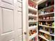 Organized pantry shelves offer ample storage next to the door at 15715 Sw 11Th Terrace Rd, Ocala, FL 34473