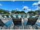 Community pool area with lounge chairs under a sunny, partly cloudy sky at 15715 Sw 11Th Terrace Rd, Ocala, FL 34473