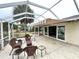 Spacious screened patio with seating area, awning and access to house at 15715 Sw 11Th Terrace Rd, Ocala, FL 34473