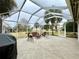 Spacious screened patio with seating area and grill at 15715 Sw 11Th Terrace Rd, Ocala, FL 34473