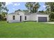 One-story home with gray garage and stone accents at 15794 Sw 55Th Ave Rd, Ocala, FL 34473