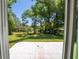 Spacious back yard with a concrete patio and mature trees, perfect for outdoor entertaining at 16434 Se 57 Pl, Ocklawaha, FL 32179