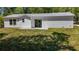 Backyard features well-maintained lawn and a sliding door to the home at 16434 Se 57 Pl, Ocklawaha, FL 32179