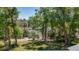 Tranquil backyard view with mature trees and pond at 16434 Se 57 Pl, Ocklawaha, FL 32179