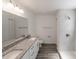 Bathroom featuring double sink vanity, granite countertop, and tile shower at 16434 Se 57 Pl, Ocklawaha, FL 32179