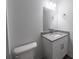 Bathroom featuring white cabinets, gray granite vanity and a large mirror at 16434 Se 57 Pl, Ocklawaha, FL 32179