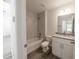 Updated bathroom with tub, shower, white cabinets, and gray granite vanity at 16434 Se 57 Pl, Ocklawaha, FL 32179