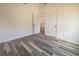 Bedroom with wood-look floors and access to bathroom at 16434 Se 57 Pl, Ocklawaha, FL 32179