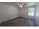 Bedroom with gray wood floors, a ceiling fan, and a closet at 16434 Se 57 Pl, Ocklawaha, FL 32179