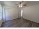 A bright bedroom with gray wood-look floors and a closet at 16434 Se 57 Pl, Ocklawaha, FL 32179