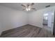 Bright bedroom featuring wood-look floors, a ceiling fan, and a window at 16434 Se 57 Pl, Ocklawaha, FL 32179
