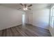 Bright bedroom featuring wood-look floors, a ceiling fan, and a window at 16434 Se 57 Pl, Ocklawaha, FL 32179