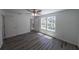 Bedroom with wood floors, ceiling fan and view into bathroom with shower at 16434 Se 57 Pl, Ocklawaha, FL 32179