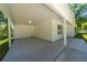 Covered carport with concrete floor and access to the home's side entrance at 16434 Se 57 Pl, Ocklawaha, FL 32179