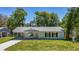 Charming single-story home featuring a covered carport and a freshly landscaped front yard at 16434 Se 57 Pl, Ocklawaha, FL 32179