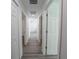 Hallway featuring gray wood-look floors with several doorways and white trim at 16434 Se 57 Pl, Ocklawaha, FL 32179