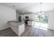 Well-lit kitchen featuring sleek white cabinets, stainless steel appliances, and an island at 16434 Se 57 Pl, Ocklawaha, FL 32179