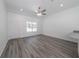 Spacious living room with gray floors, bright window, and white walls at 16434 Se 57 Pl, Ocklawaha, FL 32179