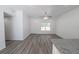 Bright living room with modern flooring, a ceiling fan, and a view into the kitchen at 16434 Se 57 Pl, Ocklawaha, FL 32179