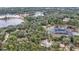 Aerial view showing two houses on a wooded lot near a lake at 16450 Se 57Th Pl, Ocklawaha, FL 32179
