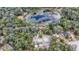 Aerial view of property showing two houses near a pond at 16450 Se 57Th Pl, Ocklawaha, FL 32179