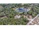 Aerial view of property showcasing two houses and a lake at 16450 Se 57Th Pl, Ocklawaha, FL 32179