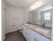 Bright bathroom features double sink vanity with granite counters and modern fixtures at 16450 Se 57Th Pl, Ocklawaha, FL 32179