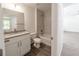 Well-lit bathroom with tiled shower/tub, granite-topped vanity, and neutral color palette at 16450 Se 57Th Pl, Ocklawaha, FL 32179