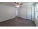 Bedroom features sleek ceiling fan, wood-look flooring, and sun-filled window at 16450 Se 57Th Pl, Ocklawaha, FL 32179