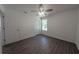 Bedroom features sleek ceiling fan, wood-look flooring, and sun-filled window at 16450 Se 57Th Pl, Ocklawaha, FL 32179