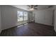 Bright bedroom with wood-look flooring, ceiling fan, two large windows and ensuite bathroom at 16450 Se 57Th Pl, Ocklawaha, FL 32179