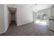 Bright dining area with a sliding glass door and view of the modern kitchen with granite countertops at 16450 Se 57Th Pl, Ocklawaha, FL 32179