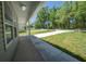 Inviting front porch with stylish gray siding and well-maintained landscaping at 16450 Se 57Th Pl, Ocklawaha, FL 32179