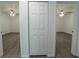 Hallway shows entry to bedrooms with wood-look flooring and bi-fold closet at 16450 Se 57Th Pl, Ocklawaha, FL 32179