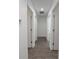 Hallway with multiple doors provides access to various rooms of the home at 16450 Se 57Th Pl, Ocklawaha, FL 32179