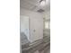 Bright hallway with grey vinyl flooring and white doors at 16450 Se 57Th Pl, Ocklawaha, FL 32179